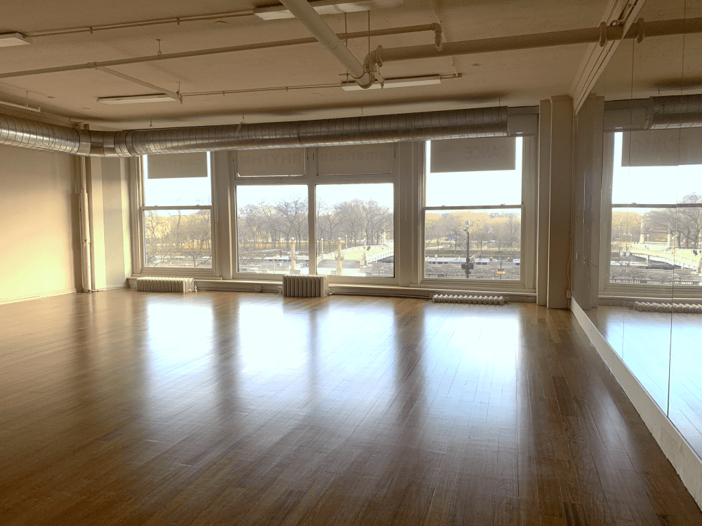 Image Description: An Annex rehearsal studio, with windows overlooking Grant Park and Lake Michigan.