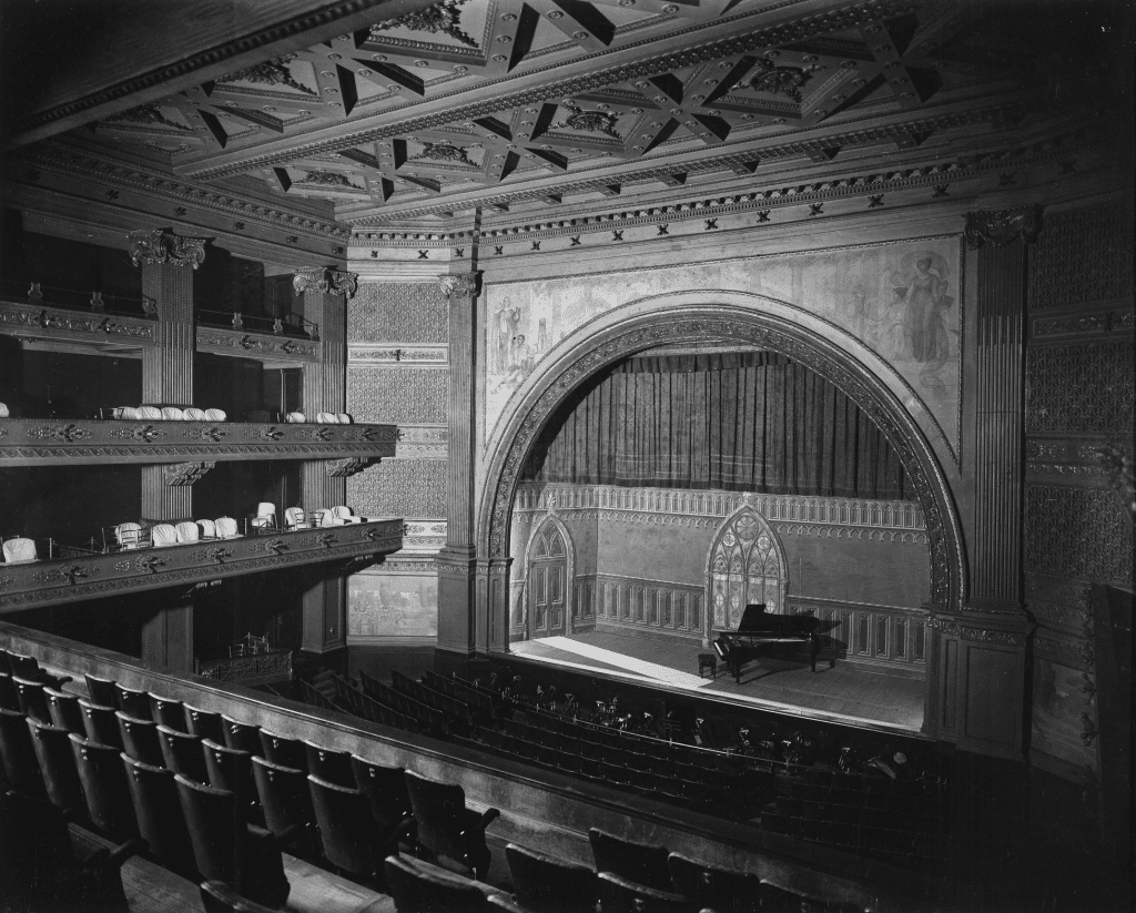 Image Description: Historic photograph of the Studebaker Theater's arched proscenium and balconies.
